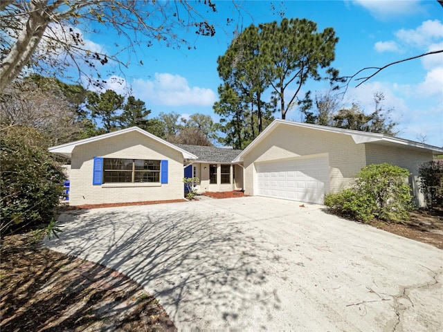 ranch-style home with an attached garage, driveway, and brick siding