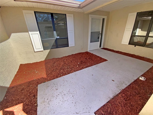 entrance to property with stucco siding