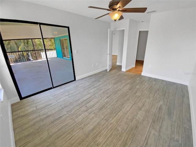 interior space featuring access to outside, baseboards, and wood finished floors