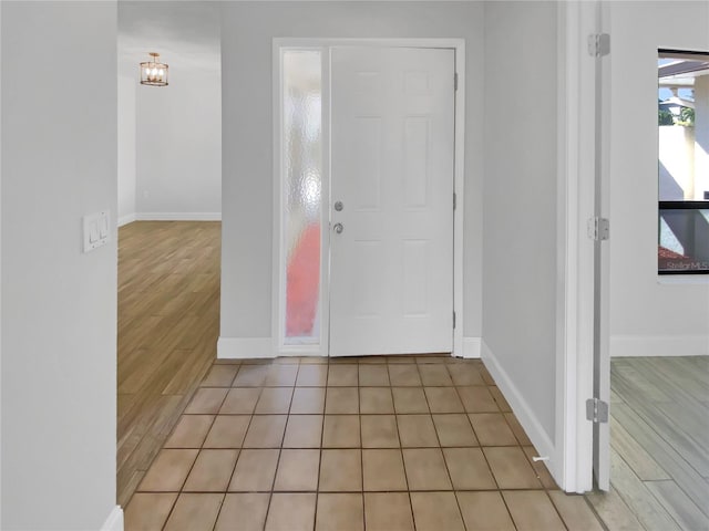 foyer featuring light wood-style floors and baseboards