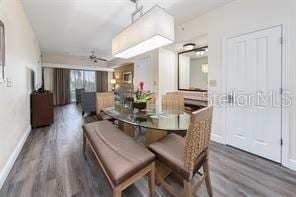 dining area featuring ceiling fan, baseboards, and wood finished floors