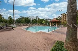 view of swimming pool with a patio and a gazebo