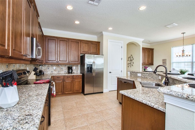 kitchen featuring appliances with stainless steel finishes, visible vents, a sink, and backsplash