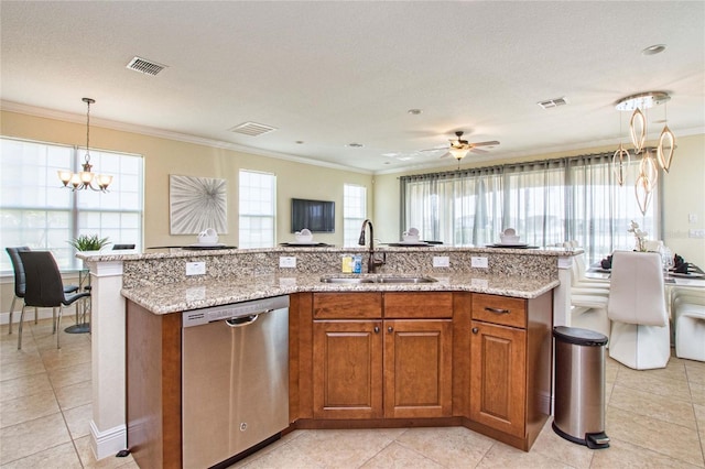 kitchen featuring a sink, visible vents, brown cabinetry, and stainless steel dishwasher