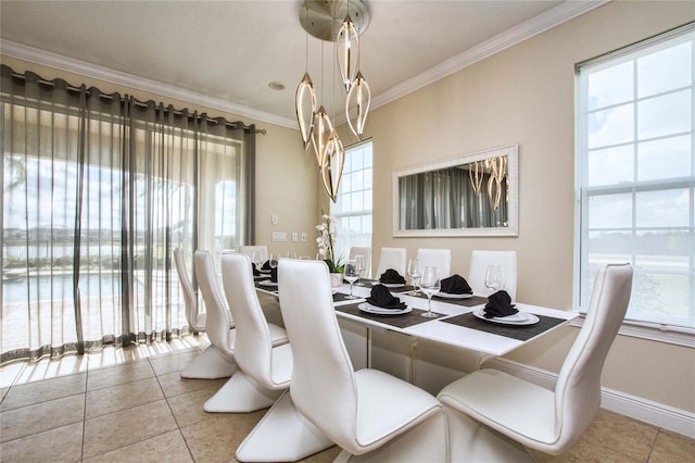 tiled dining space featuring crown molding and baseboards