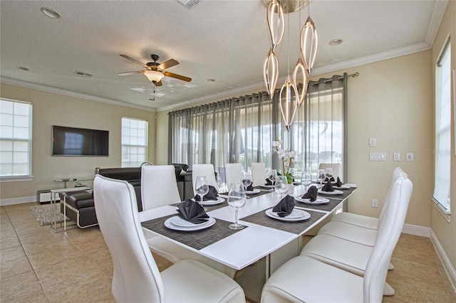 dining space featuring ornamental molding, a ceiling fan, a textured ceiling, baseboards, and tile patterned floors