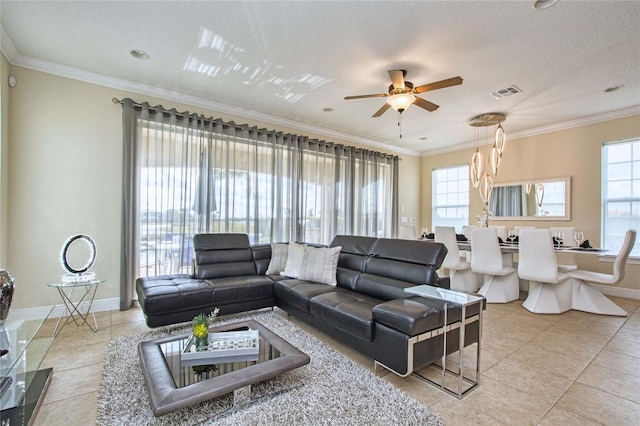 tiled living room with baseboards, a healthy amount of sunlight, and crown molding