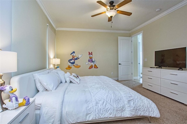 carpeted bedroom featuring ceiling fan, baseboards, and crown molding