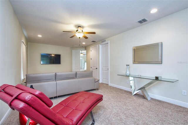 carpeted living room with ceiling fan, a textured ceiling, recessed lighting, visible vents, and baseboards