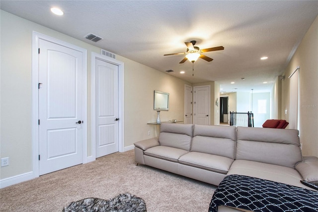 living area featuring carpet, visible vents, and baseboards