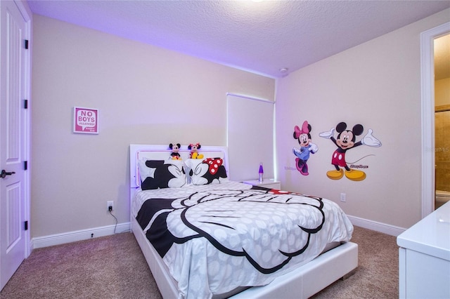 carpeted bedroom with baseboards and a textured ceiling