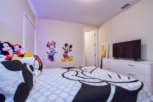 bedroom with visible vents and a textured ceiling