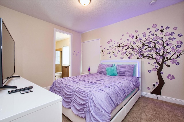 bedroom with carpet floors, ensuite bath, baseboards, and a textured ceiling