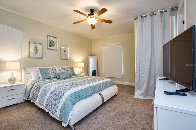 bedroom with dark carpet and a ceiling fan