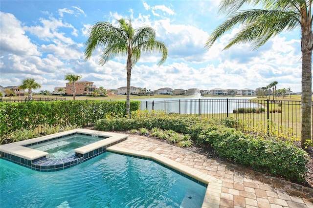 view of swimming pool with a pool with connected hot tub, a water view, and fence