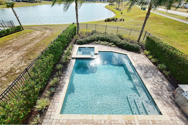 view of pool featuring a pool with connected hot tub, a water view, a yard, and a fenced backyard