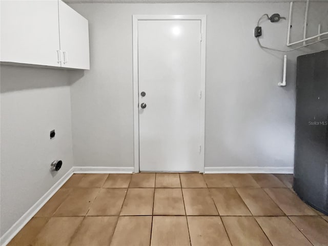 laundry room with cabinet space, tile patterned flooring, baseboards, and electric dryer hookup