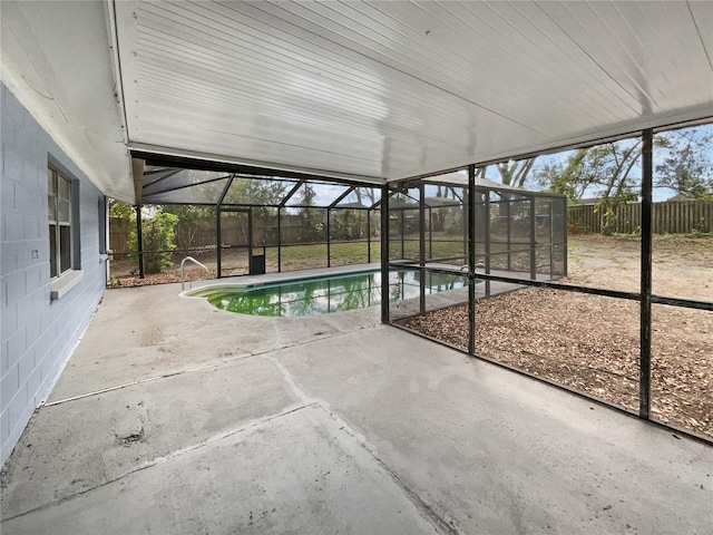 pool with a patio, a fenced backyard, and glass enclosure