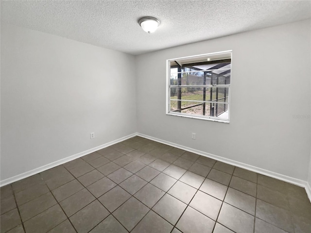 unfurnished room featuring baseboards and a textured ceiling