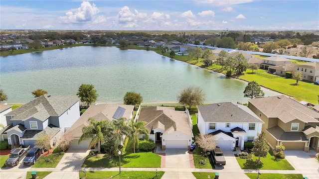 drone / aerial view with a water view and a residential view