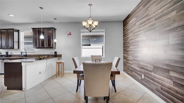 dining area featuring a wealth of natural light, baseboards, an inviting chandelier, and light tile patterned floors