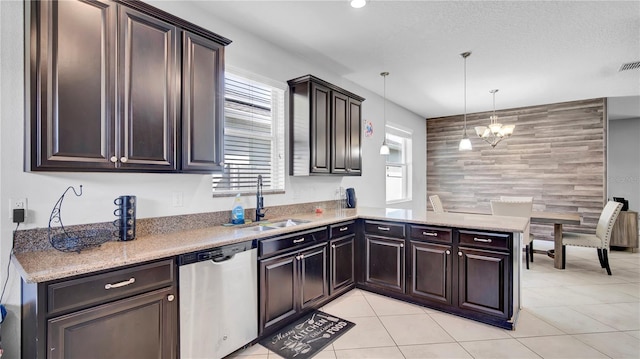 kitchen with a notable chandelier, an accent wall, a sink, dishwasher, and a peninsula