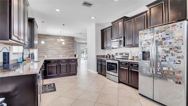 kitchen with light tile patterned floors, visible vents, appliances with stainless steel finishes, a sink, and dark brown cabinets