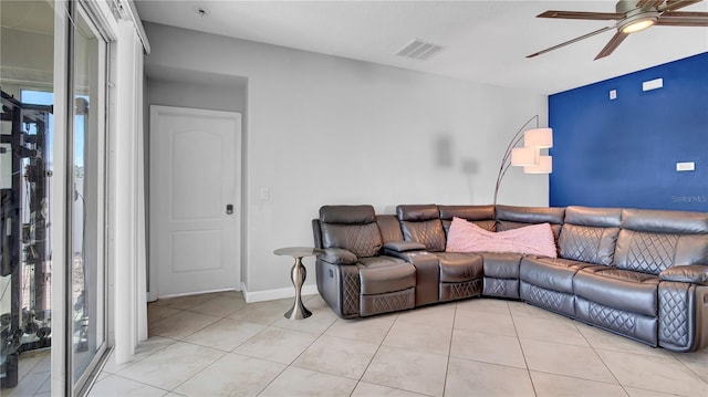 living area with light tile patterned floors, visible vents, and a ceiling fan