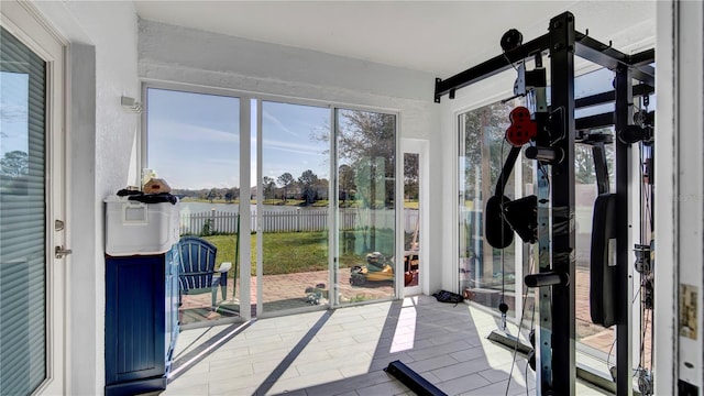 interior space featuring a textured wall and a water view