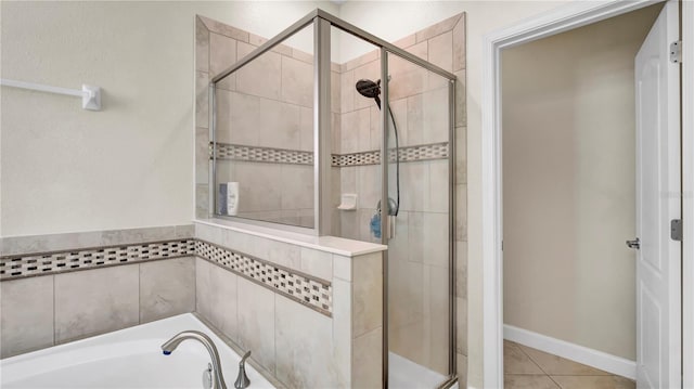 full bath with a stall shower, a garden tub, and tile patterned floors