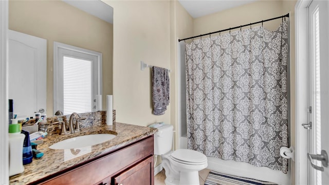 full bath with shower / bath combo, vanity, and toilet