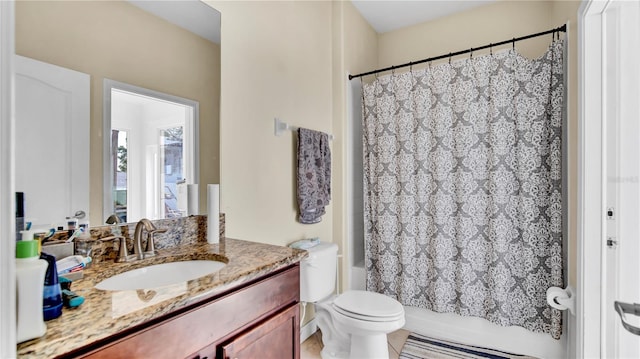 bathroom featuring shower / bath combo, vanity, and toilet