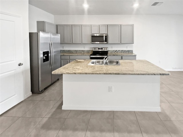 kitchen with visible vents, appliances with stainless steel finishes, gray cabinetry, a sink, and light tile patterned flooring