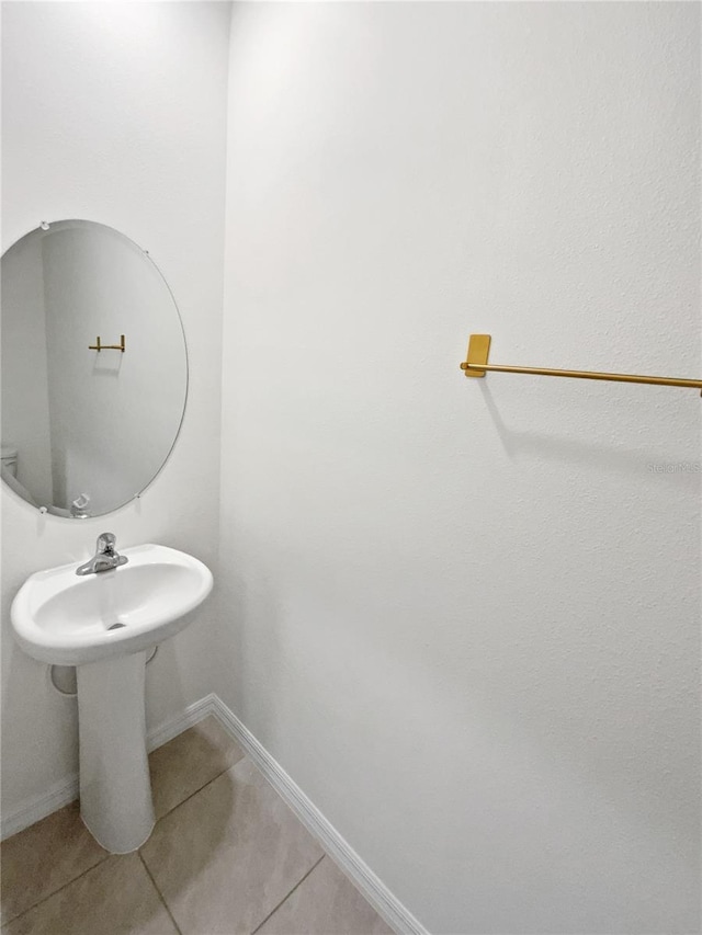 bathroom with tile patterned flooring and baseboards