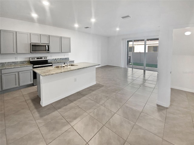 kitchen featuring a sink, appliances with stainless steel finishes, gray cabinets, and visible vents