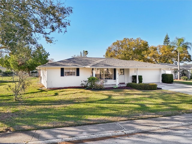 ranch-style home with a garage, fence, concrete driveway, and a front yard