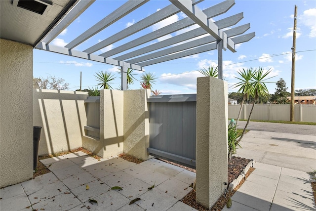 view of patio featuring fence and a pergola