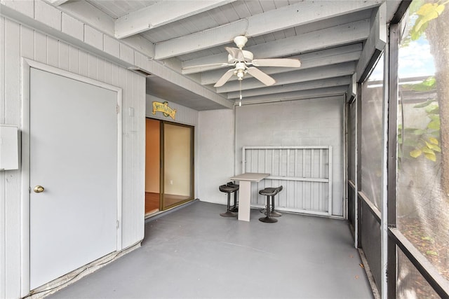 interior space featuring a ceiling fan and beamed ceiling