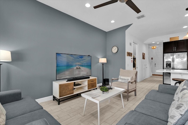 living room with visible vents, baseboards, ceiling fan, and wood tiled floor