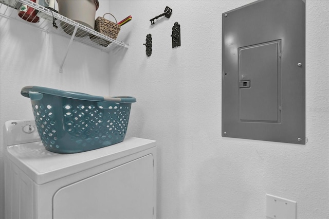 laundry room featuring electric panel, washer / clothes dryer, and laundry area