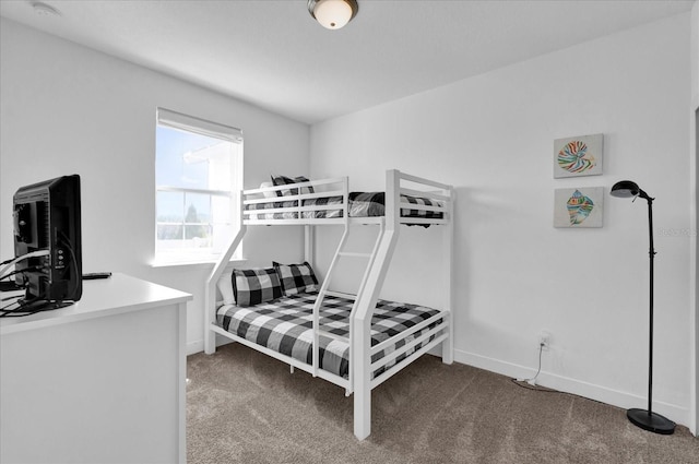 bedroom featuring carpet flooring and baseboards