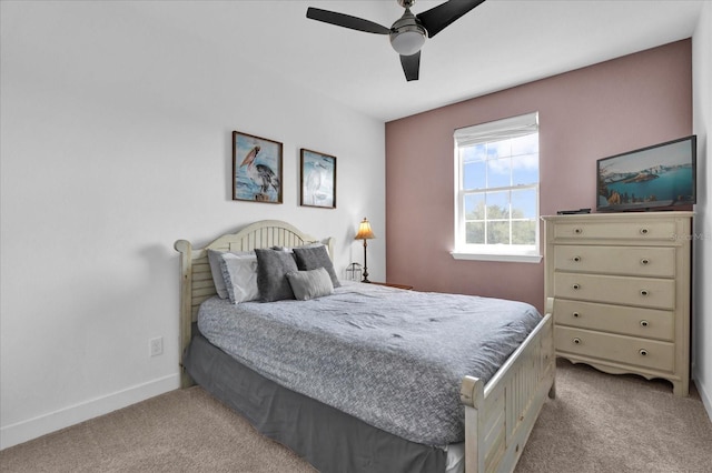 carpeted bedroom featuring baseboards and ceiling fan