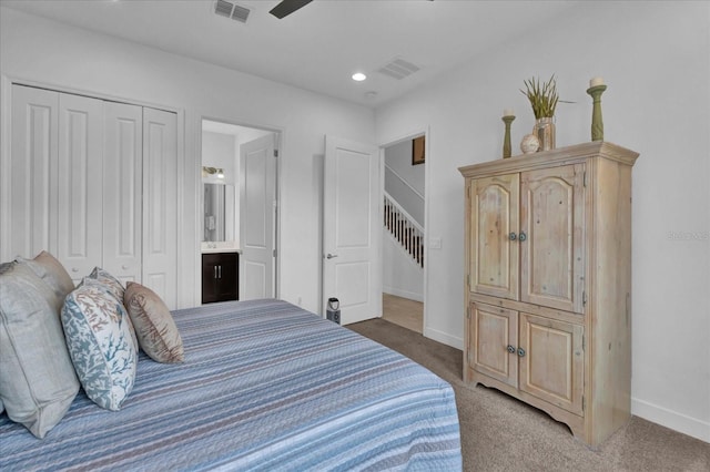 carpeted bedroom with visible vents, baseboards, and a closet