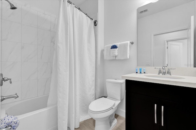 bathroom featuring vanity, wood finished floors, shower / bathtub combination with curtain, visible vents, and toilet