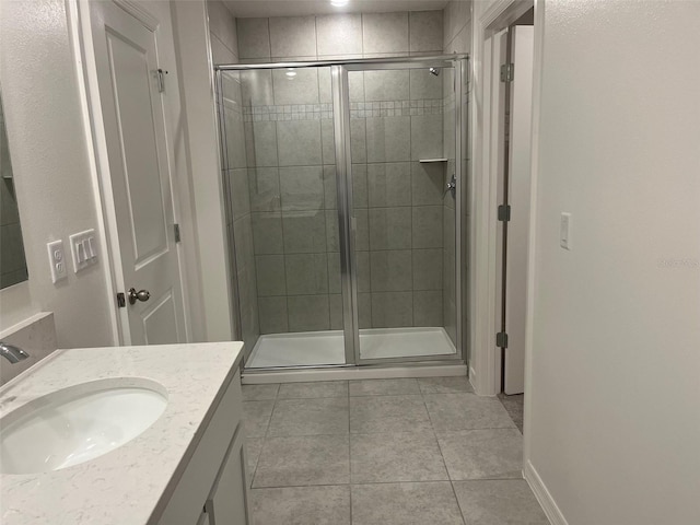 2005 Canton Park Dr, Winter Haven, FL 33881 - bathroom featuring vanity, tile patterned floors, baseboards, and a shower stall