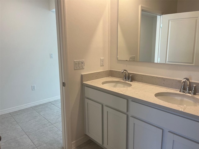 2005 Canton Park Dr, Winter Haven, FL 33881 - bathroom featuring double vanity, baseboards, a sink, and tile patterned flooring