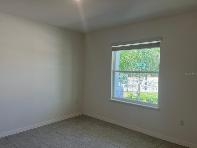 2005 Canton Park Dr, Winter Haven, FL 33881 - empty room with a healthy amount of sunlight, baseboards, and light tile patterned floors