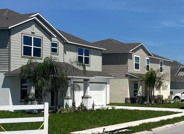 2005 Canton Park Dr, Winter Haven, FL 33881 - view of front of property featuring an attached garage, a shingled roof, and a front lawn