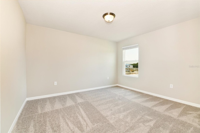 empty room with carpet and baseboards