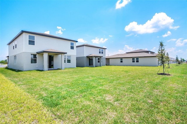 rear view of property with a lawn